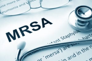 Word MRSA with a stethoscope to illustrate antibiotic-resistance