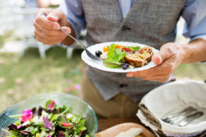 man holding plate of food