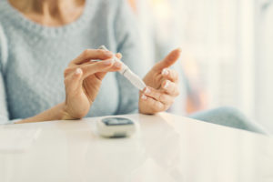 woman doing blood sugar test