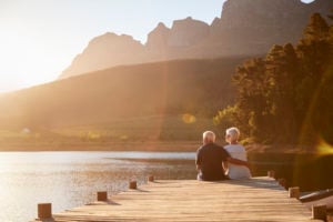 senior couple sitting on pier