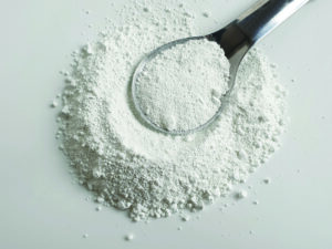 Titanium dioxide powder in a spoon