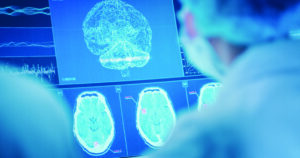 Scientists studying brainwave scanning models.