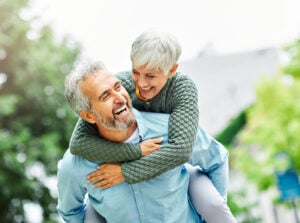 Senior couple full of energy do piggyback ride