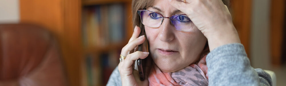 Senior woman on phone feeling stress.