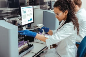 Woman scientist conducting hair analysis test.