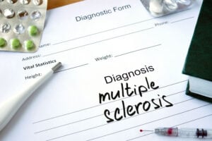 Doctor's diagnosis pad of paper with the words multiple sclerosis or MS written on it