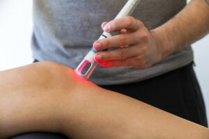 Light therapy on a knee used to treat pain. 