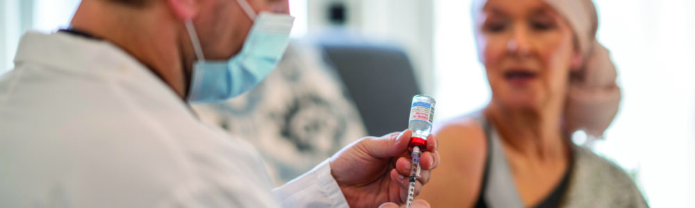 A patient receiving mRNA vaccine from doctor.